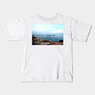 Calm Adriatic sea surrounded by massive rocks under the light blue sky Kids T-Shirt